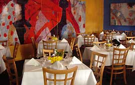 Mozaic murals and wall hangings provide color and texture to the second flloor private room.
